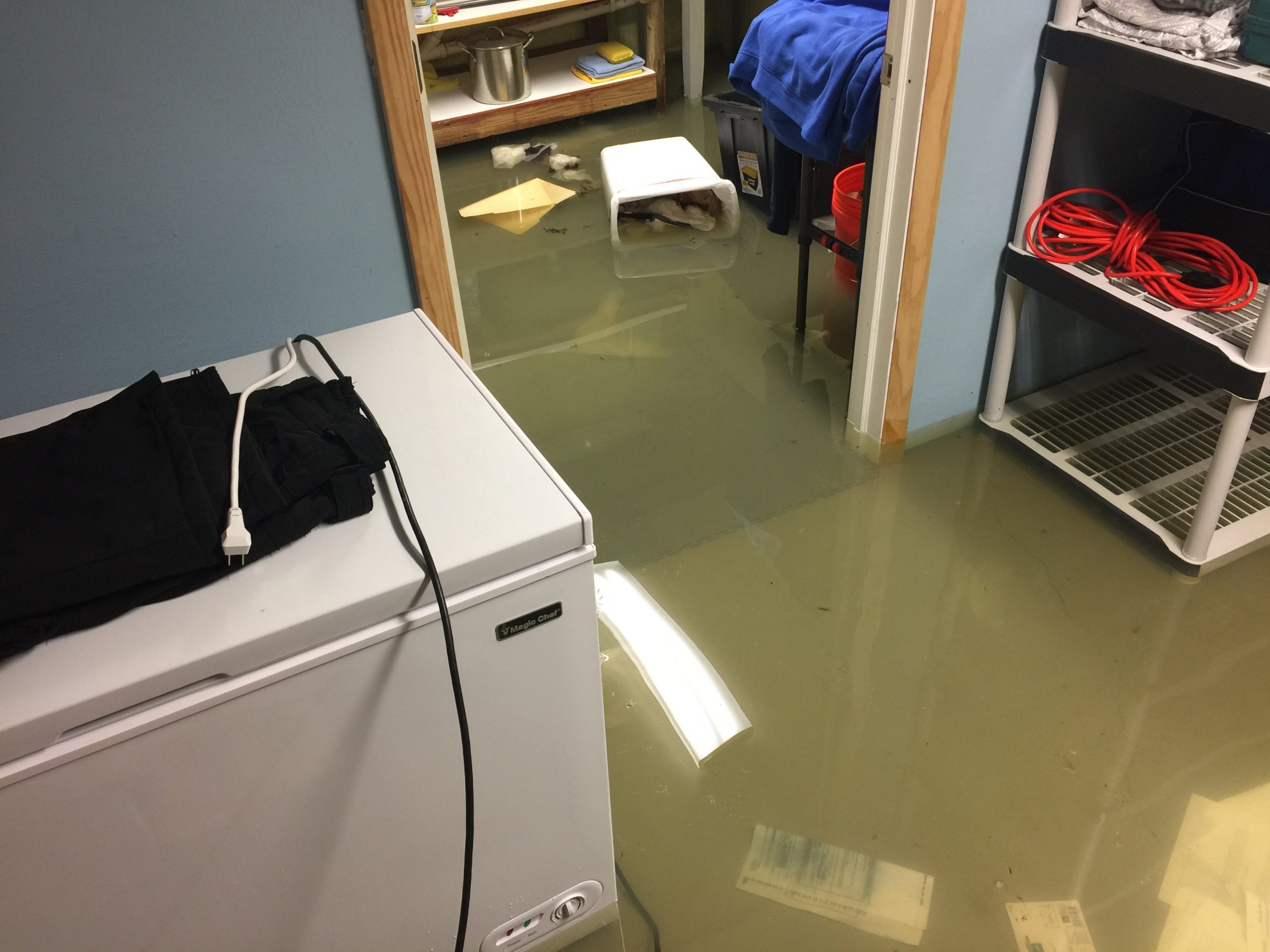 Flooded basement with homeowner's possessions floating around