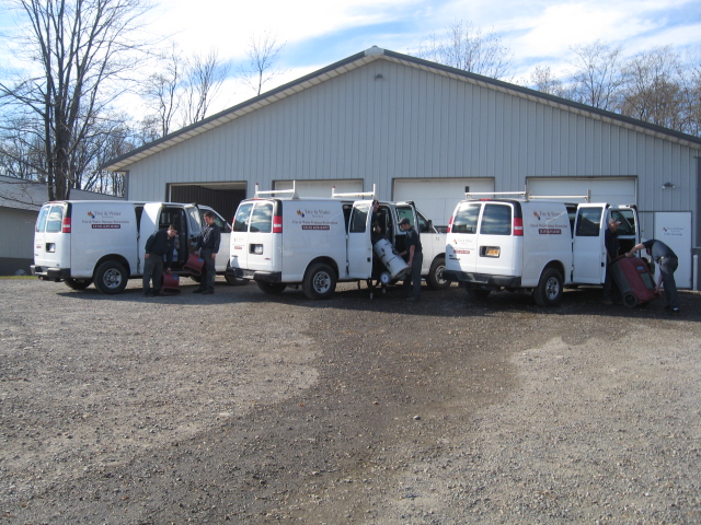 Fire and Water Restoration vans being loaded up by certified technicians before heading to jobs